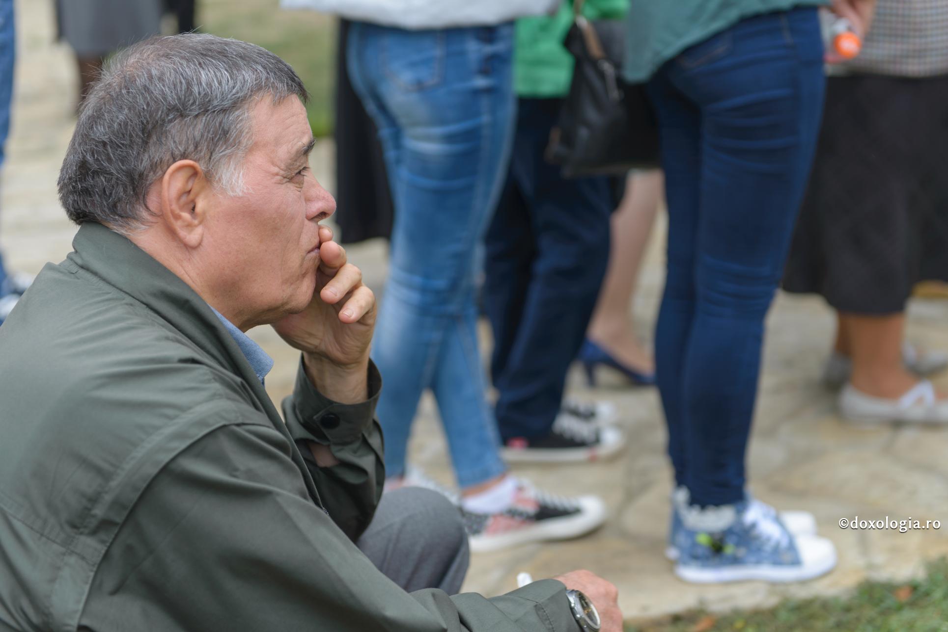 bărbat cu mâna la gură