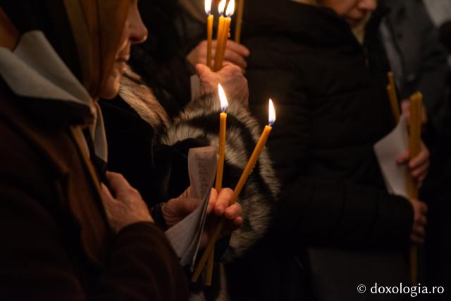 Credincioși care aduc pomelnicul la altar