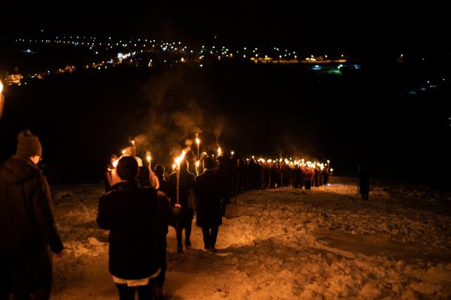 (Foto) Cu Steagul României și cu torțe aprinse – studenții au sărbătorit la Mănăstirea Putna încheierea Anului Centenar 