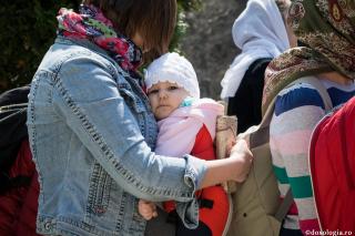 mamă cu pruncul în brațe