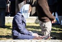 femeie stând în genunchi la slujbă